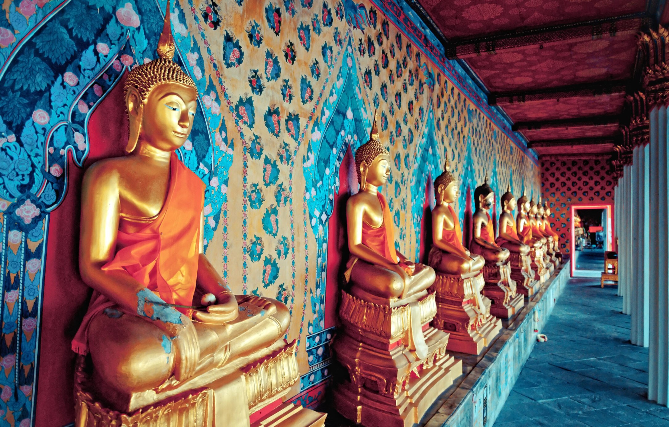 golden statues of Buddha in Wat Arun temple, Bangkok